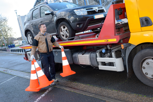 a tow truck takes away a broken car